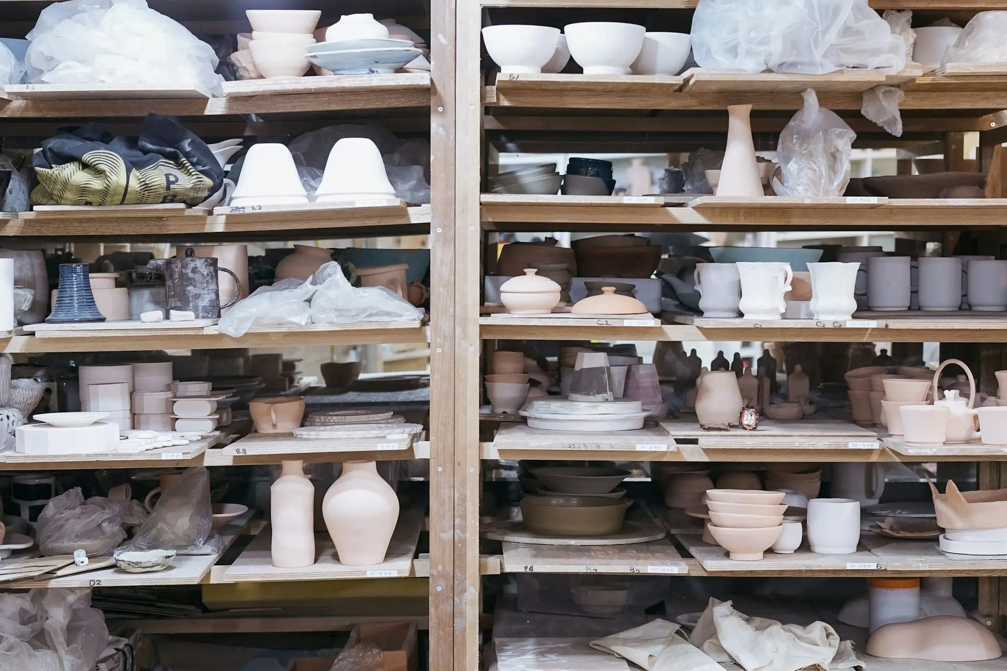 Pottery studio shelves stacked with handmade ceramics