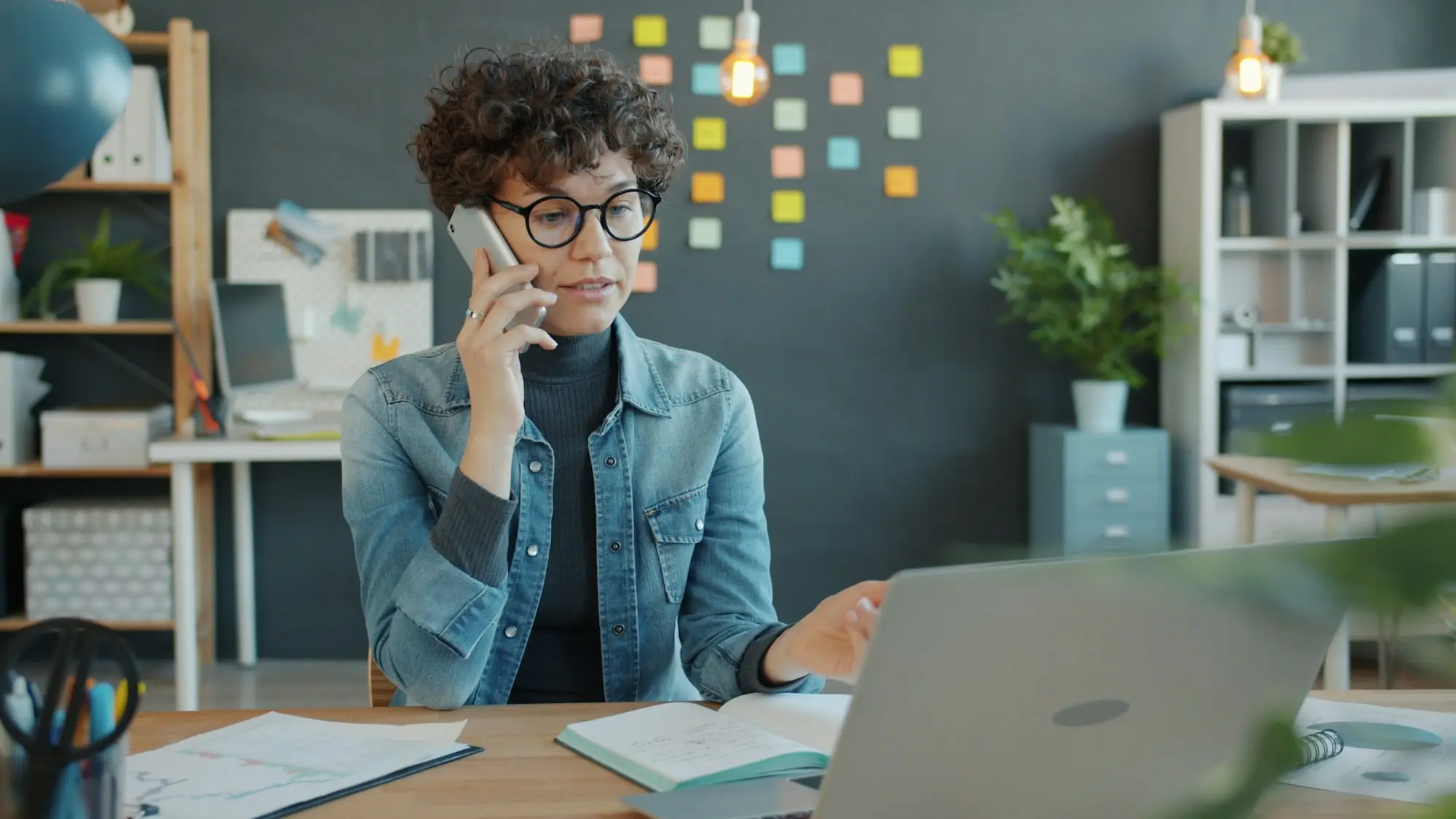 Specialist taking a phone call at her office desk