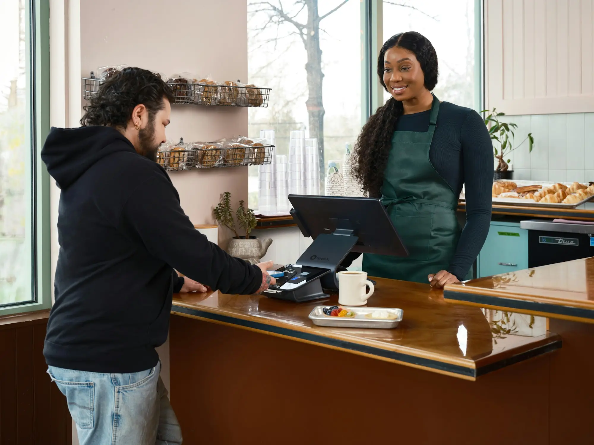 Couple running the counter of their small bakery and cafe
