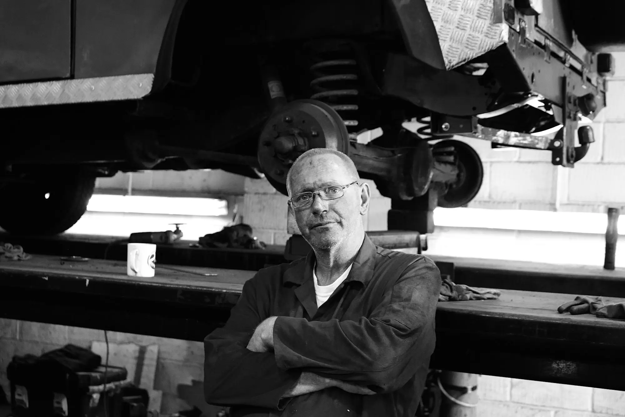 Workshop owner sitting among his machinery